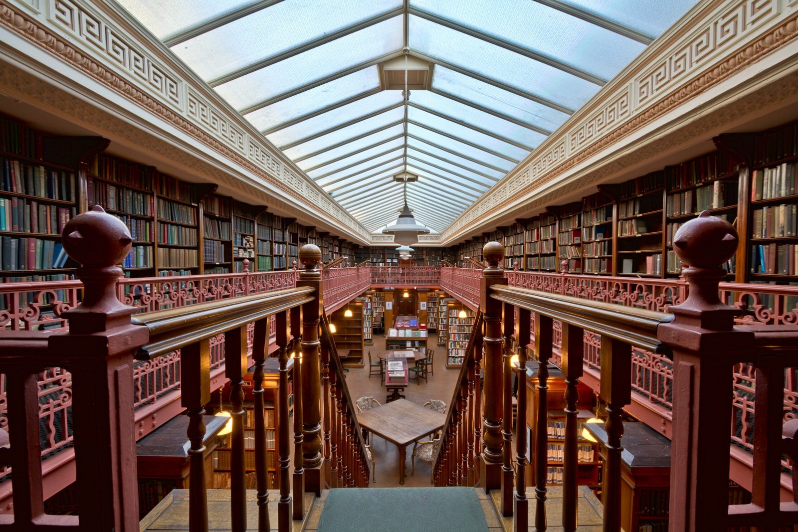 A library filled with lots of books and a skylight